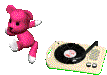 a gif of a little pink bear dancing next to a record player